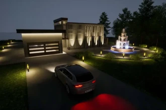front of house at night with garage and fountain